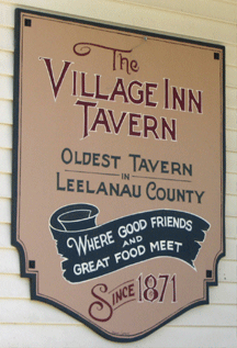 Village Inn Sign on Suttons Bay Building on the porch